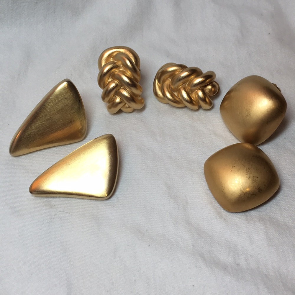 Three gold clip on earrings.